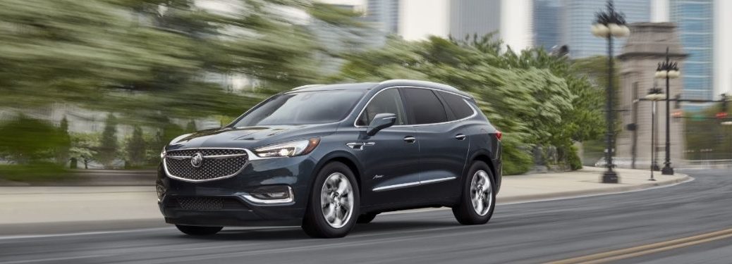 A 2021 Buick Enclave driving on the city road.