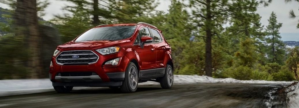 The 2021 Ford EcoSport driving on a road surrounded by trees.