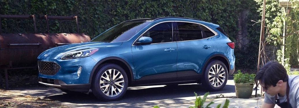 Side view of a 2021 Ford Escape parked near a garden.