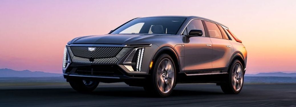 front quarter view of the 2023 Cadillac Lyriq under a pink and purple sky