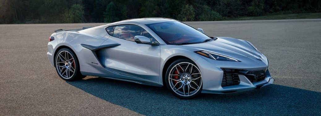 Side view of a silver-colored 2023 Chevrolet Corvette Z06 sports car parked on tarmac