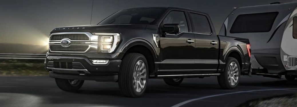 A black 2022 Ford F-150 towing a trailer