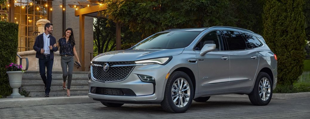 A couple walking towards the 2022 Buick Enclave