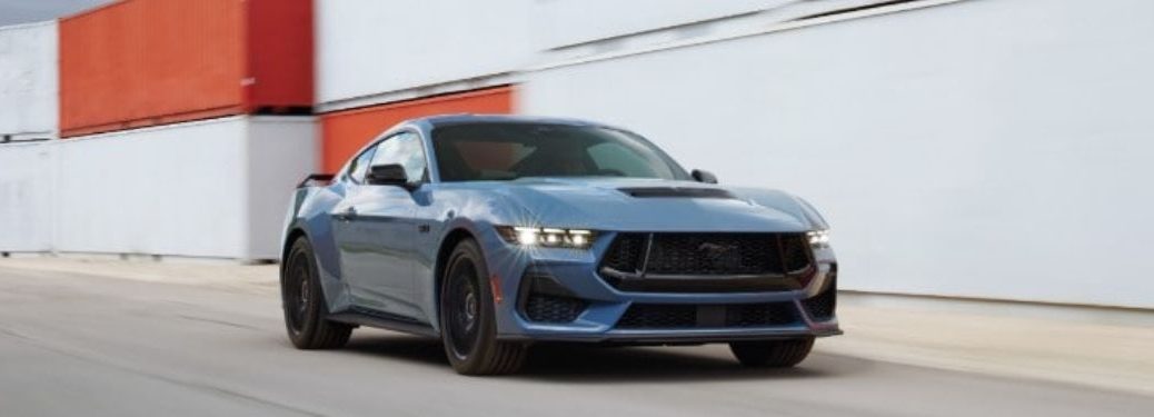 A 2024 Ford Mustang zipping on a container road