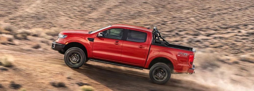 A red 2023 Ford Ranger going up hill.
