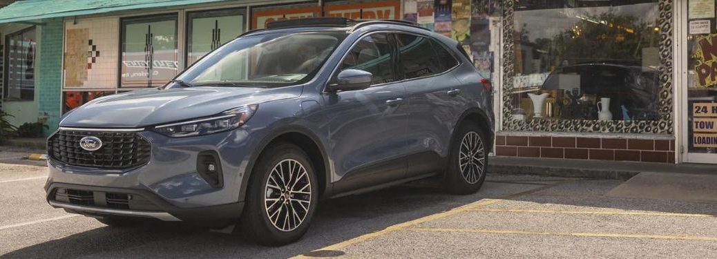 A grey 2023 Ford Escape parked outside a building.