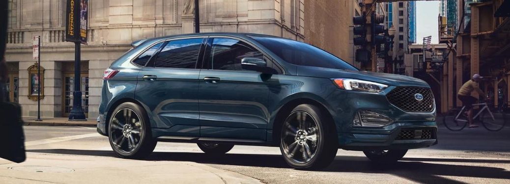 Side view of a blue 2023 Ford Edge parked in the city.