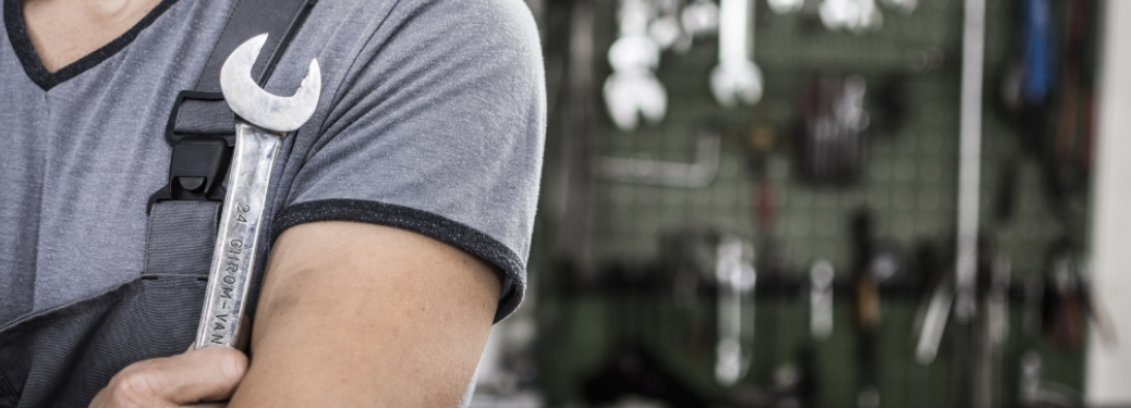 Mechanic posing with a tool