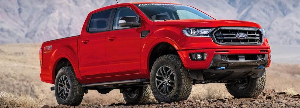 A red 2023 Ford Ranger on a rocky terrain.