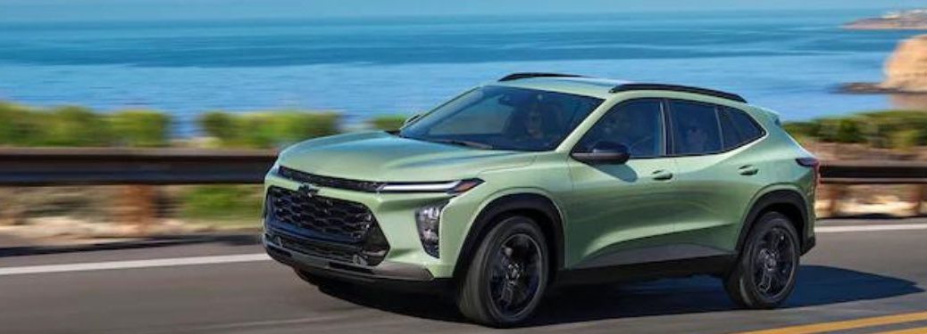 A green 2024 Chevrolet Trax on the highway.