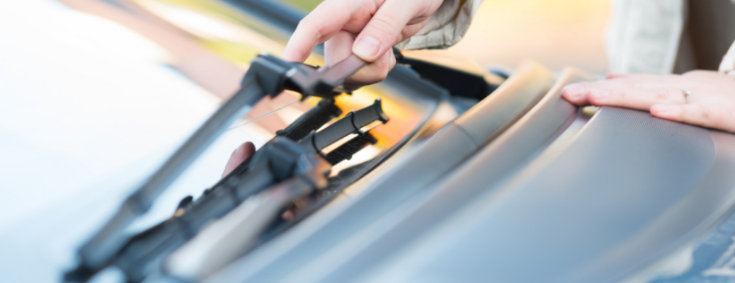 A man checking the windshield wiper