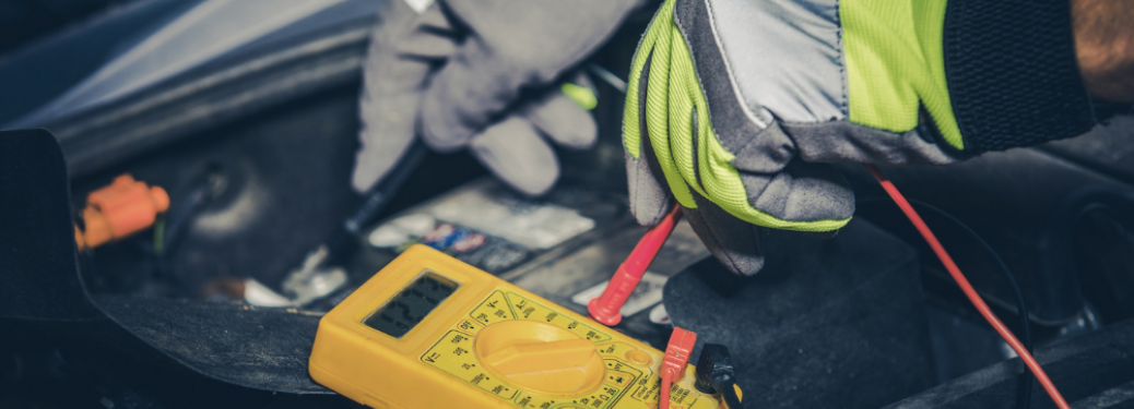 A mechanic inspecting a vehicle's battery