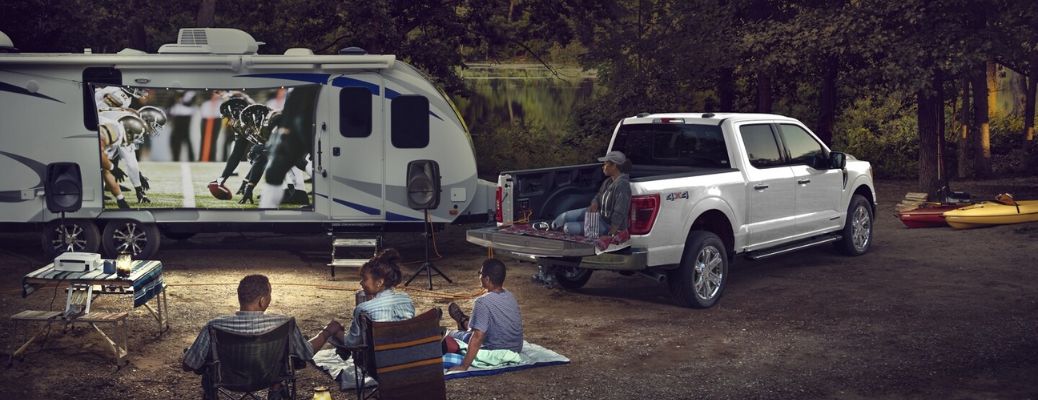 Friends using the Pro Power Onboard of the 2024 Ford F-150 to watch a soccer match