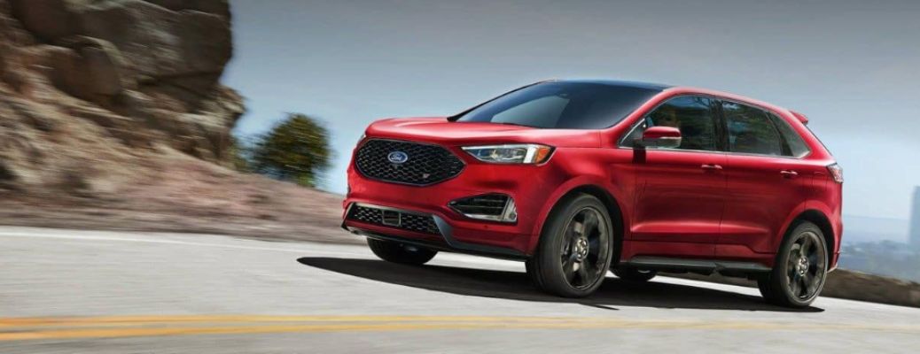 One red color 2024 Ford Edge is running on the road.