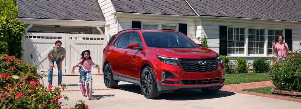 A kid cycling near the 2024 Chevrolet Equinox