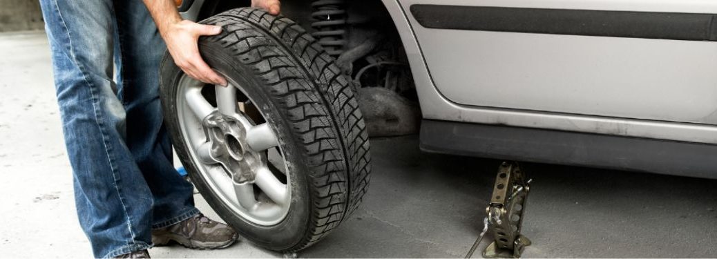 Technician changing a vehicle's tire