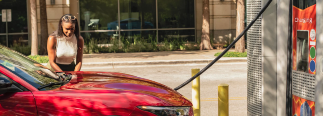 A woman charging her vehicle