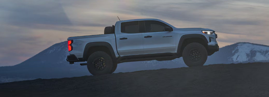 Side view of the 2024 Chevrolet Colorado with background of mountains