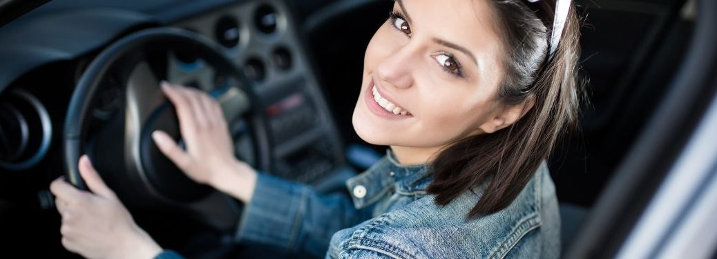 a smiling woman in driving seat