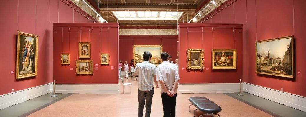 two men standing in a museum