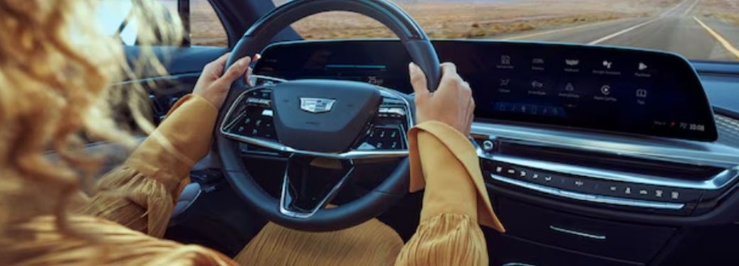 a woman driving a Cadillac
