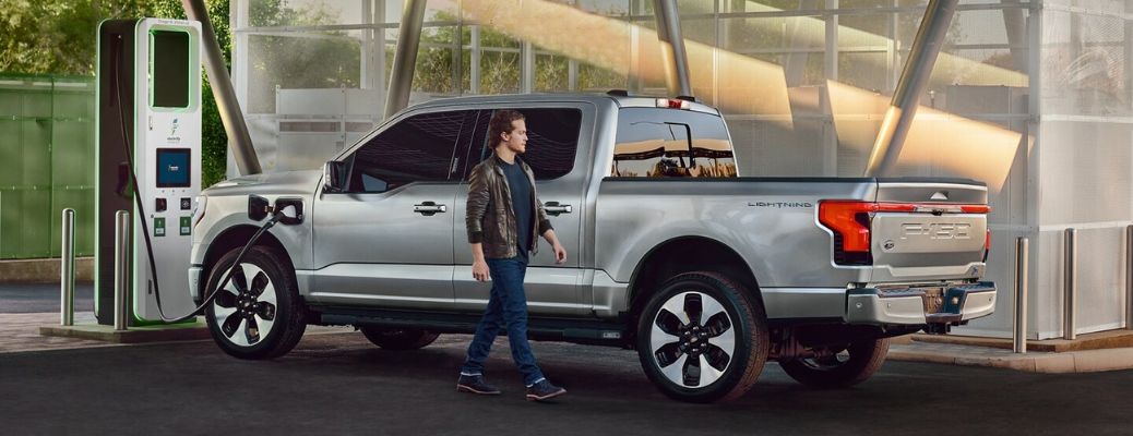 a man walking towards an EV