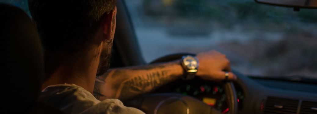 image of a man driving a car