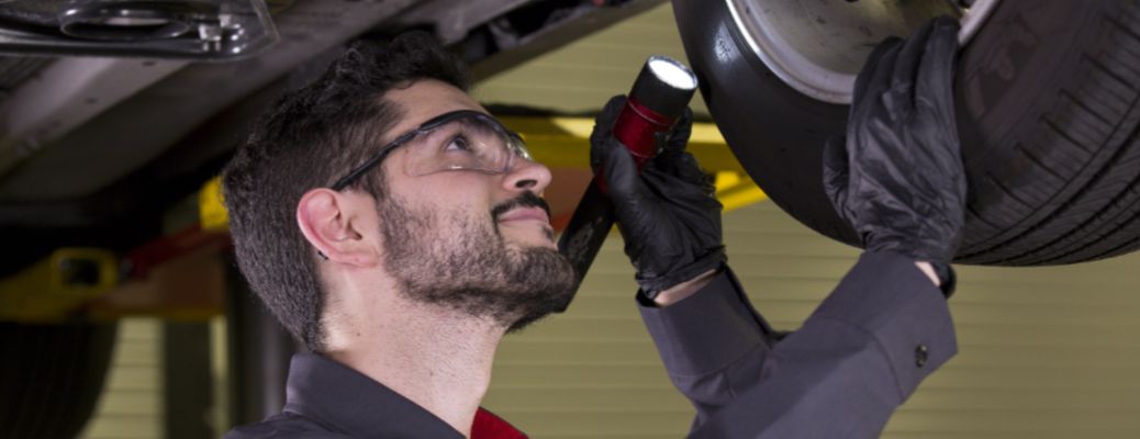a technician checking a tire