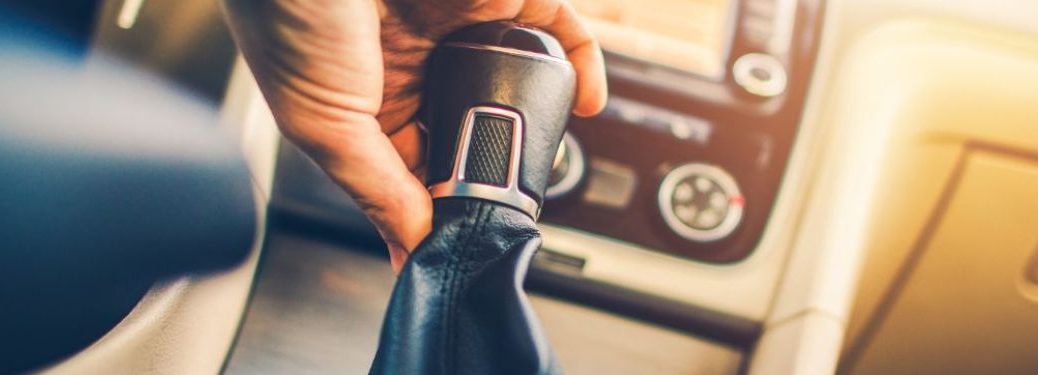 hand of a person changing gear of car