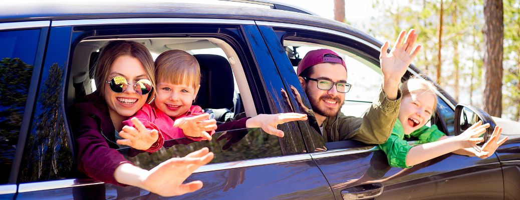 A happy family inside a car
