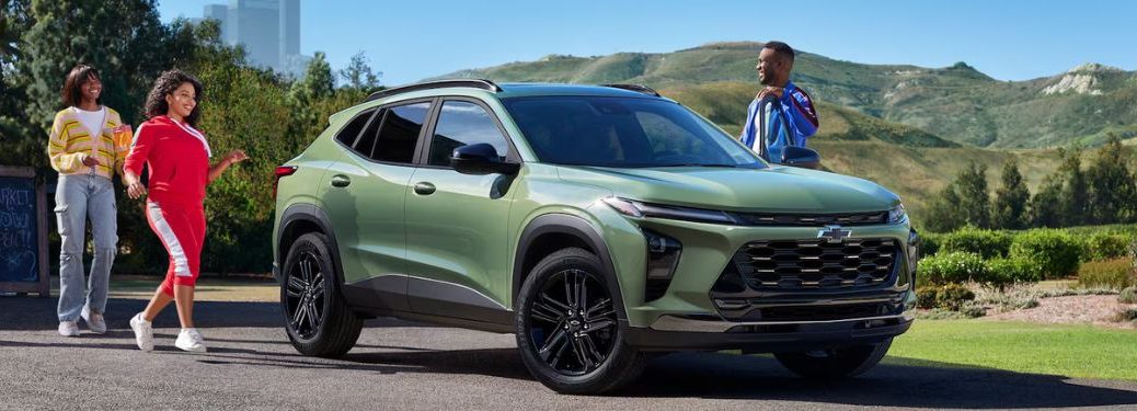 Several people standing behind the 2026 Chevrolet Trax