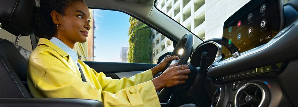 A woman driving a Chevrolet vehicle