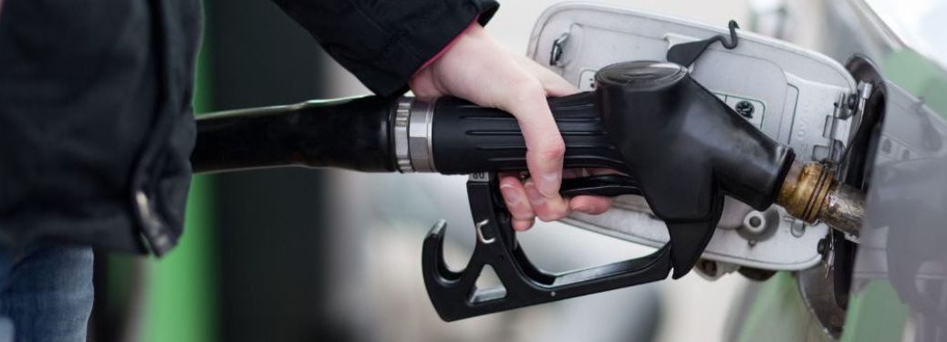 Hand of a man fueling a vehicle
