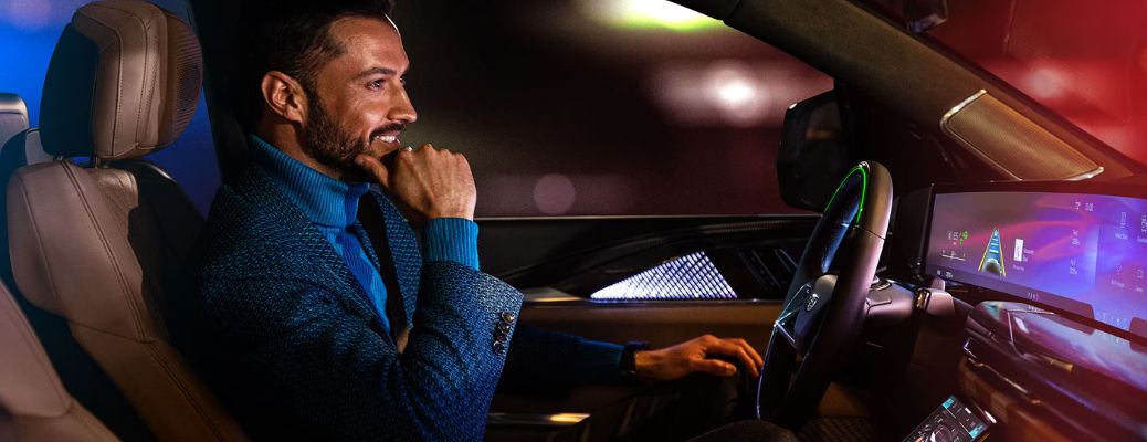 Man driving a Cadillac vehicle