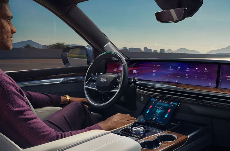 A man sitting inside a Cadillac vehicle