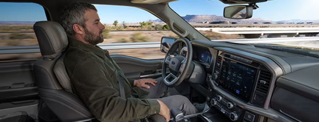 A man driving his Ford vehicle