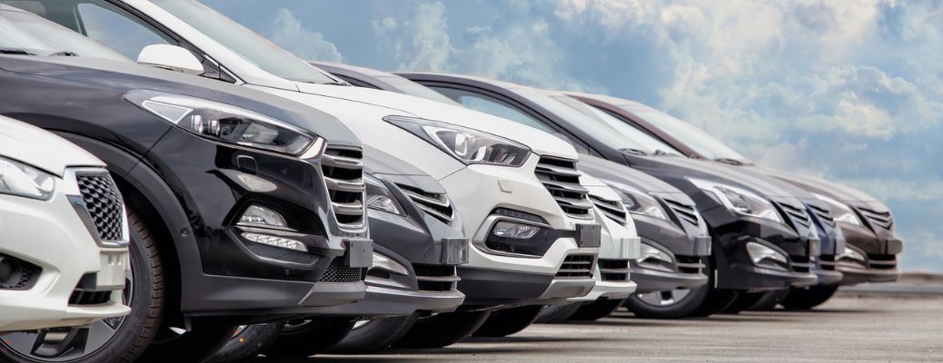 cars lined up in a dealership lot