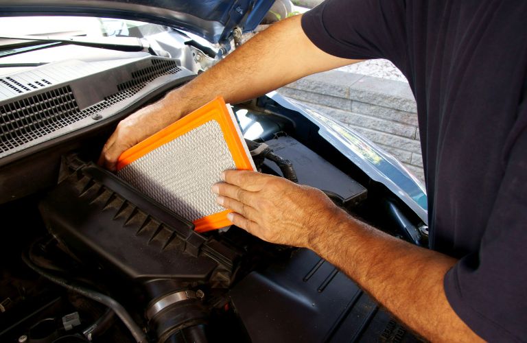 Technician putting in a new air filter