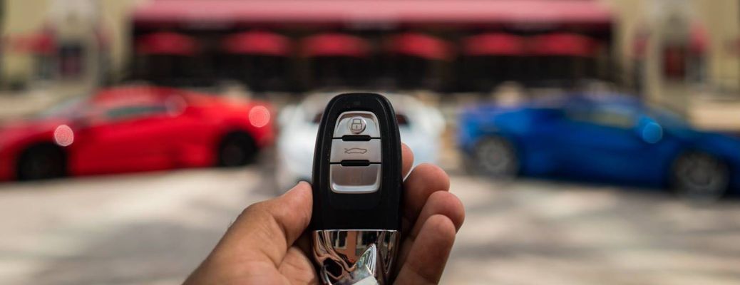 a hand holidng a Lamborghini key