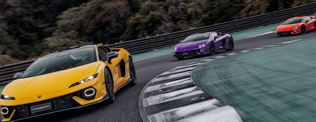 front view of Lamborghini vehicles on a track