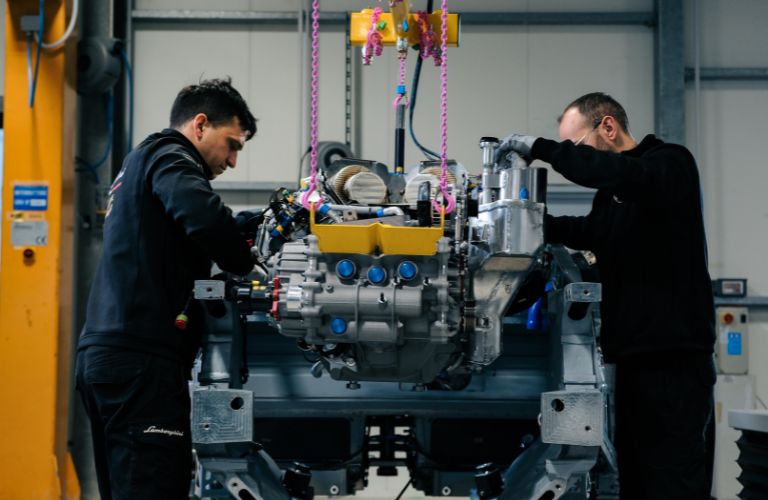 Two mechanics working on the Lamborghini Temerario GT3