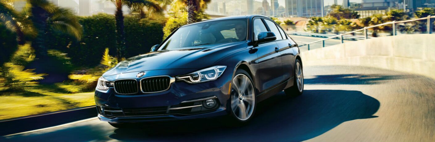 BMW 3 Series driving on city road