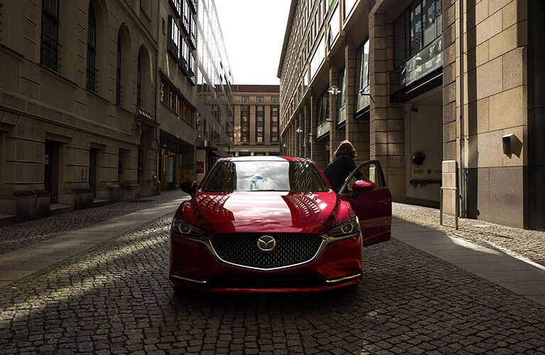 Woman Opening the Door of a Red 2018 Mazda6