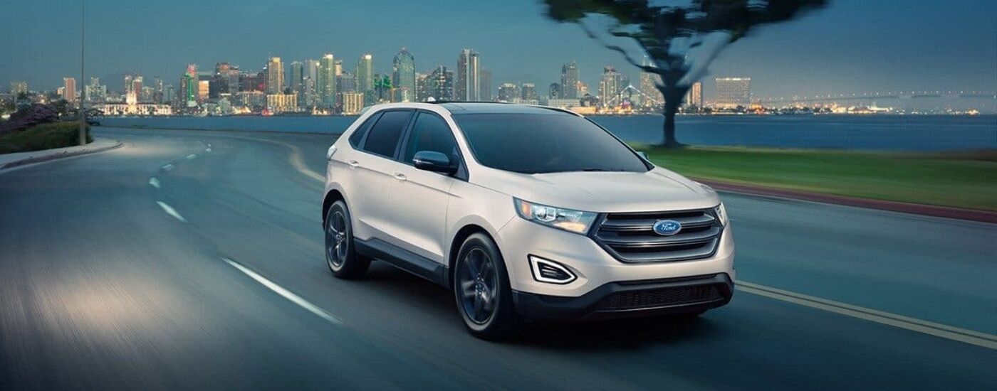 White 2018 Ford Edge driving past a city
