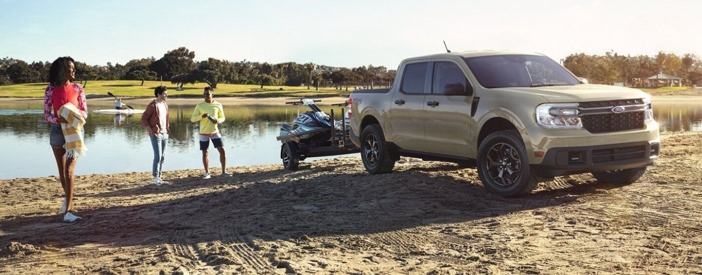Tan 2024 Ford Maverick XLT towing jetskis