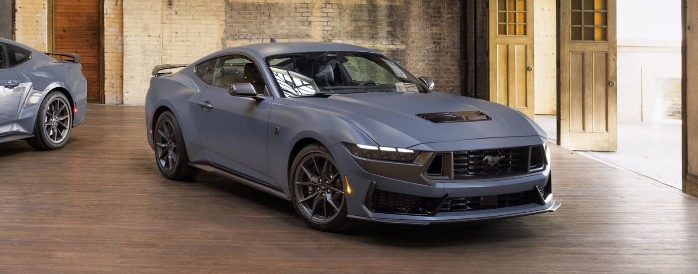 Grey 2024 Ford Mustang Dark Horse parked in a warehouse