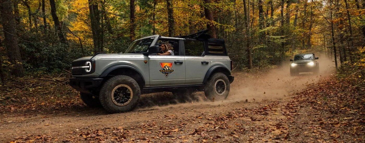 Grey 2025 Ford Bronco Badlands driving on a trail