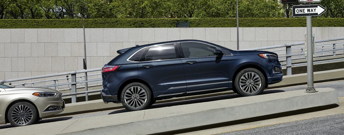 A blue 2022 Ford Edge Titanium Elite parked on a hill.