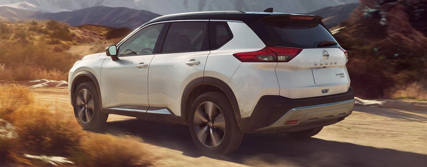 White 2021 Nissan Rogue driving off-road.