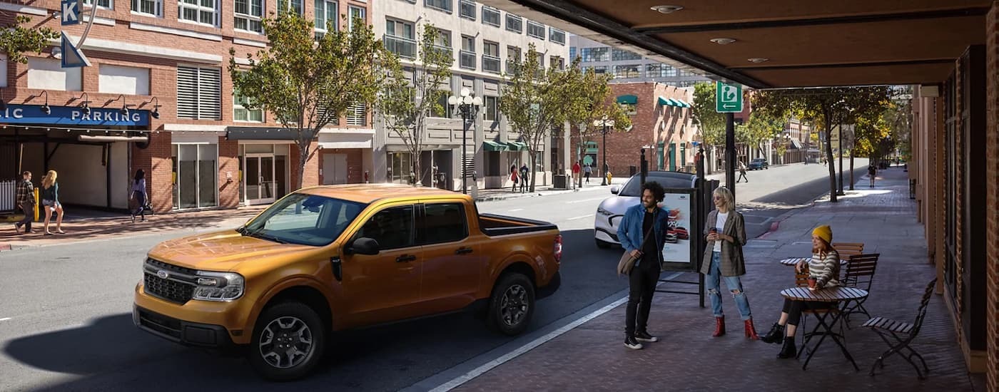 Gold 2022 Ford Maverick parked on the side of a city street